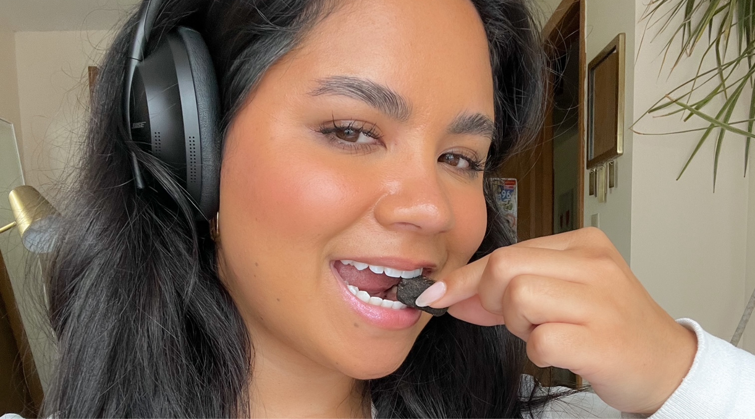 women wearing headphones eating GEM vitamin bite