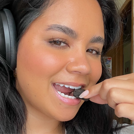 women wearing headphones eating GEM vitamin bite
